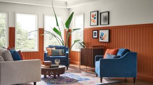 sitting room painted orange and white, with chairs and a house plant