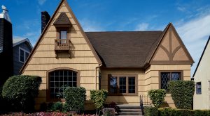 home with two large gables and freshly painted shake siding