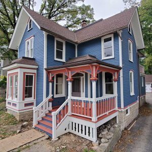 Two-story home painted blue, pink, and white