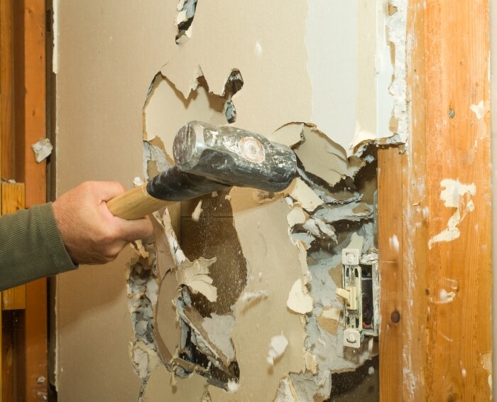 Man Breaking the damaged Drywall - Two-Day Painting